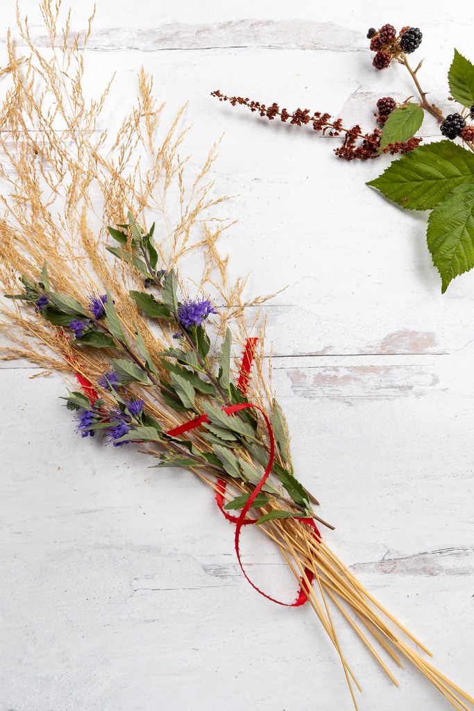 A loose bundle of dried grasses, flowers, seed heads, and foliage