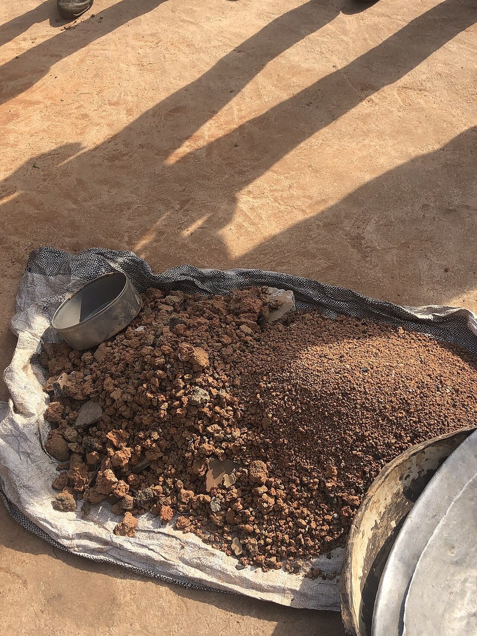 A close view of dense reddish-brown clay-rich soil